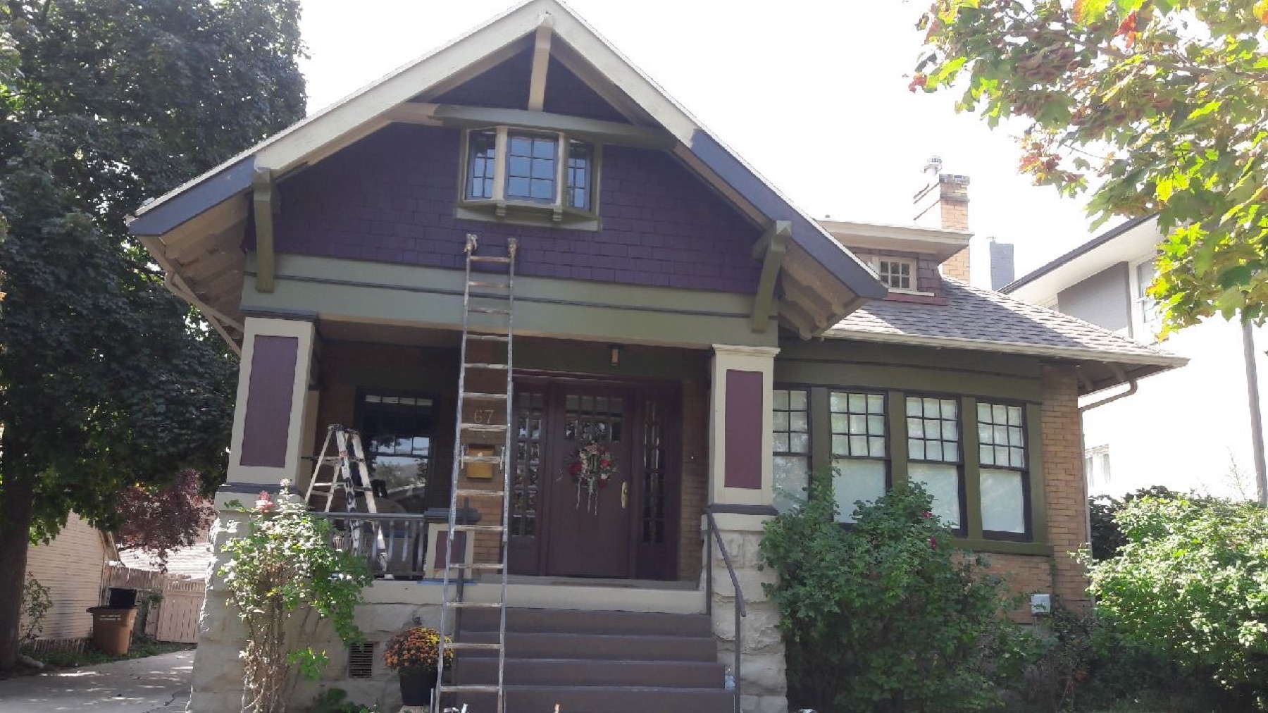 Craftsman bungalow exterior repaint in progress, with ladder against the porch