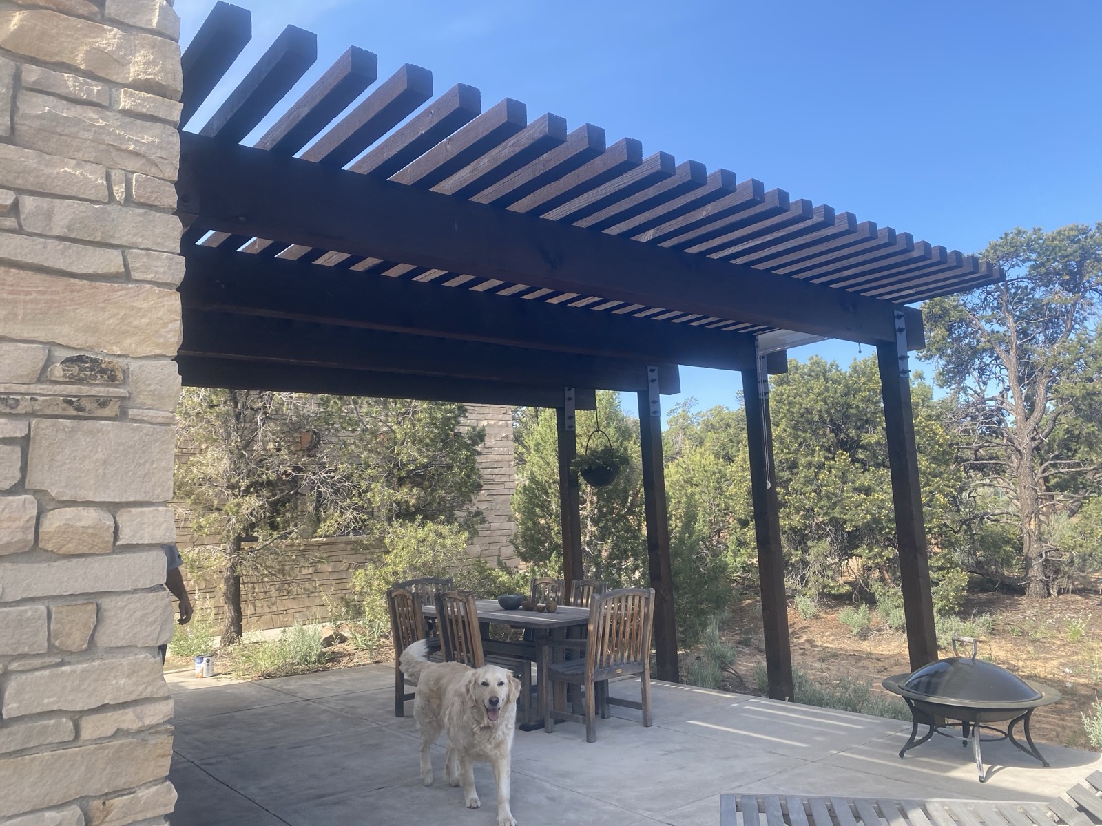 Timber patio cover and stonework built by Focus Custom Wallworks on a Garfield County home