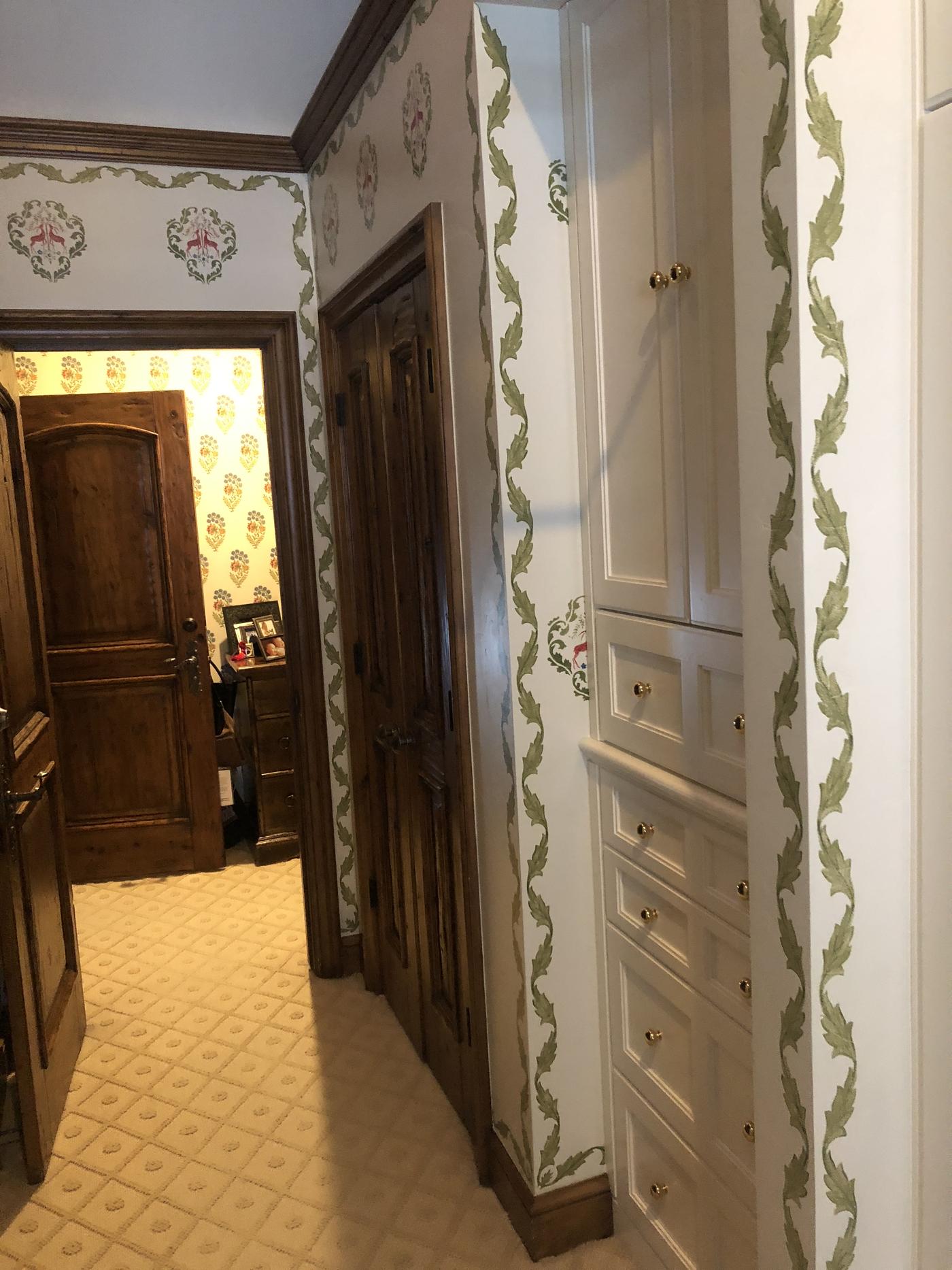 Hand-stenciled decorative wall border painted along a ceiling line