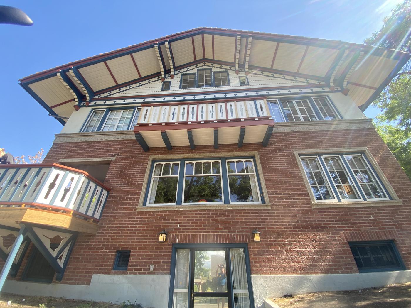 Historic chalet with restored decorative trim, brick and timber
