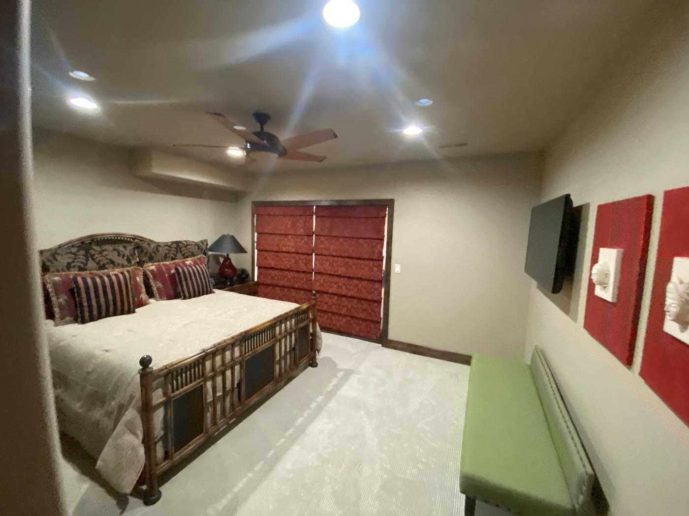 Bedroom with deep red accent wall