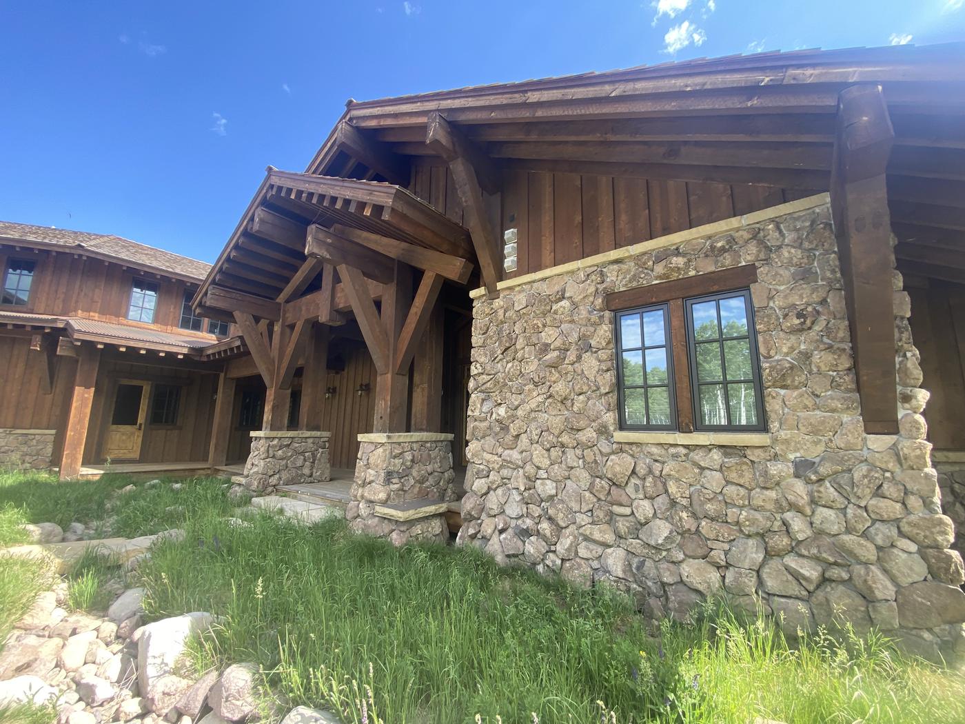 Stone and timber lodge home with completed exterior restoration